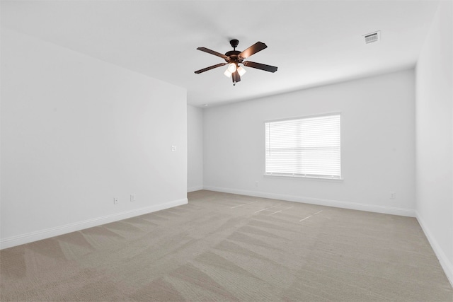 unfurnished room featuring ceiling fan and light colored carpet