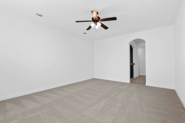 unfurnished room with ceiling fan and light carpet