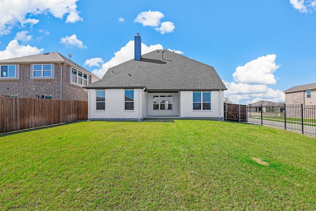 back of house with a lawn