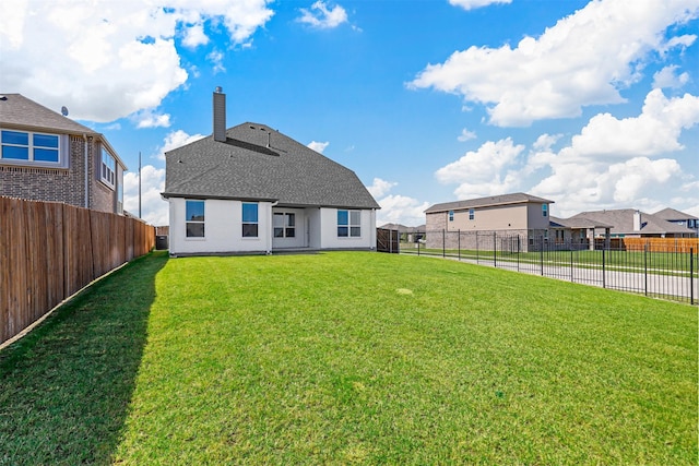 back of house featuring a yard