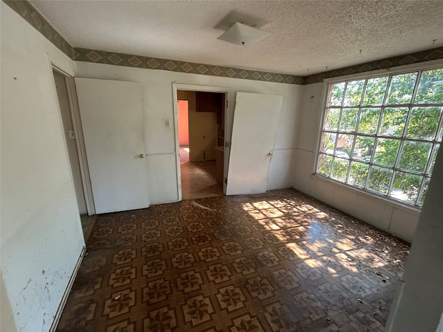 spare room with a textured ceiling