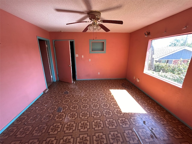 spare room with ceiling fan and a textured ceiling