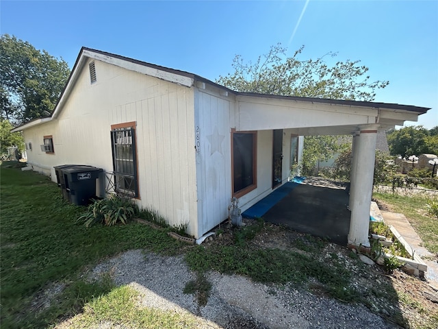 view of side of home featuring a carport