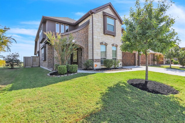 view of front of home with a garage and a front lawn