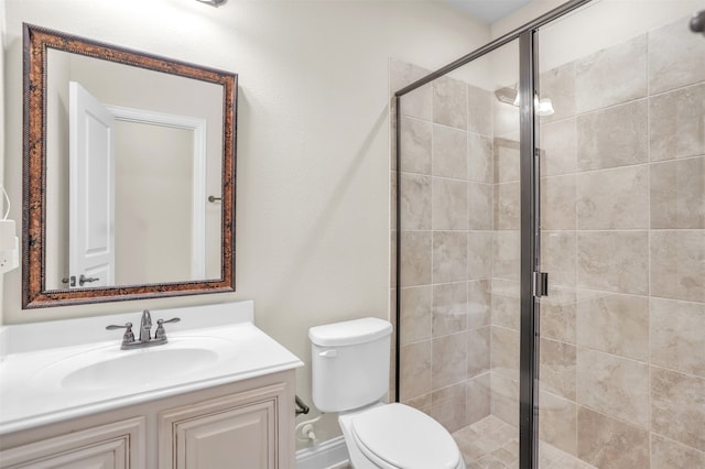 bathroom with vanity, toilet, and an enclosed shower