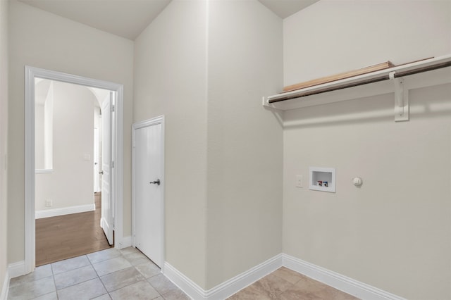 clothes washing area with gas dryer hookup, washer hookup, and light tile patterned floors