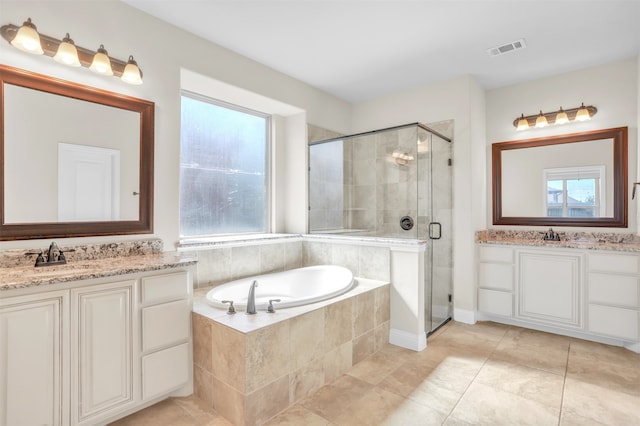 bathroom with vanity, a wealth of natural light, tile patterned floors, and plus walk in shower