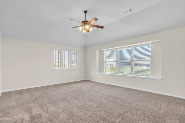 carpeted spare room with lofted ceiling and ceiling fan