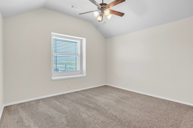 spare room with vaulted ceiling, ceiling fan, and carpet