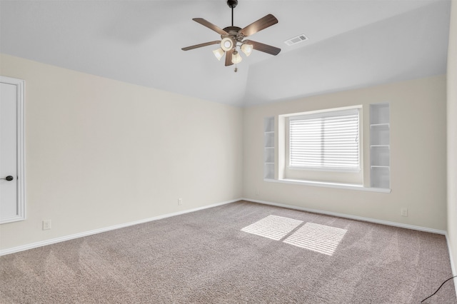 carpeted spare room with lofted ceiling and ceiling fan