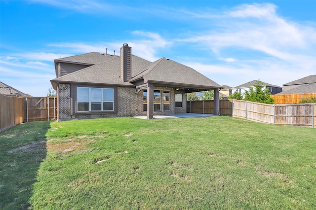 rear view of property with a patio and a yard