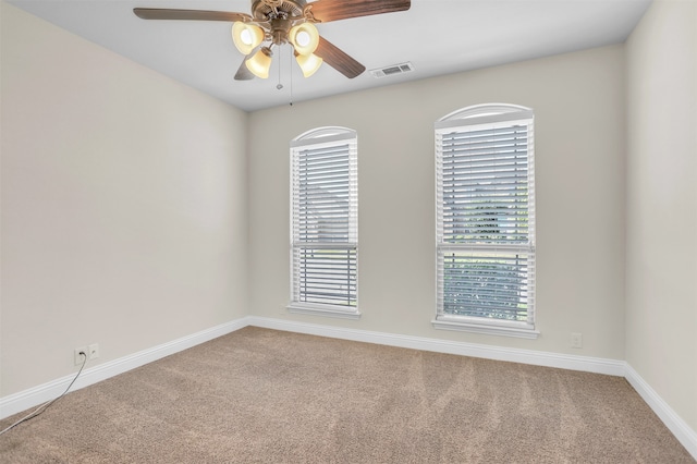 spare room featuring ceiling fan and carpet