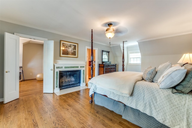 bedroom featuring hardwood / wood-style flooring, ceiling fan, and crown molding