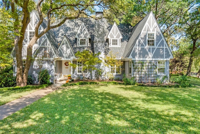 tudor home featuring a front lawn