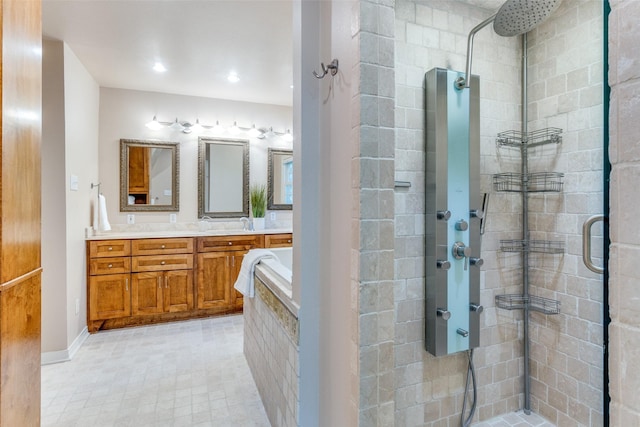 bathroom featuring vanity and independent shower and bath