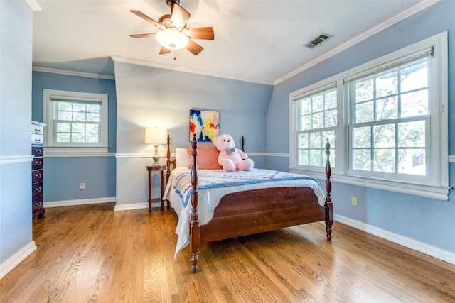 bedroom with ornamental molding, ceiling fan, and light hardwood / wood-style flooring