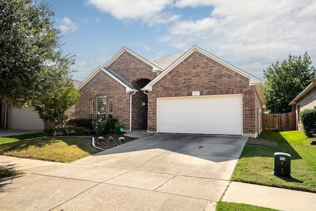 view of front of property featuring a garage and a front lawn