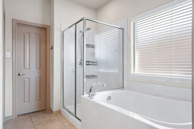 bathroom featuring tile patterned floors and independent shower and bath