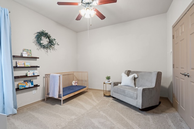 carpeted bedroom featuring a closet and ceiling fan