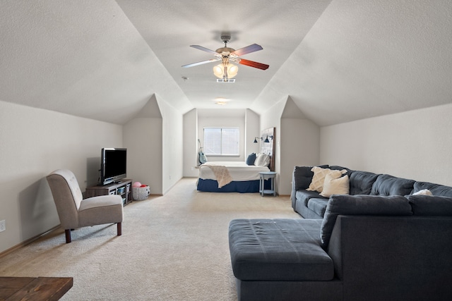 carpeted living room with vaulted ceiling, a textured ceiling, and ceiling fan