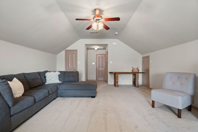 living room featuring lofted ceiling, ceiling fan, and light carpet