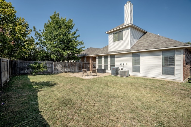 back of house featuring a yard, central AC, and a patio area