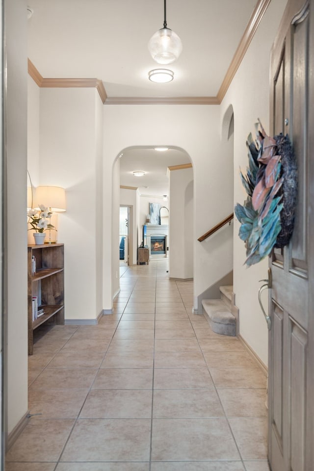 hall featuring crown molding and light tile patterned floors