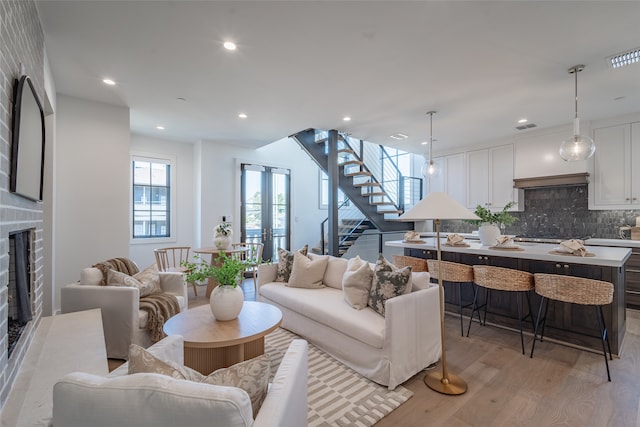 living room with french doors and light hardwood / wood-style floors