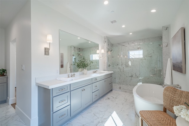 bathroom featuring vanity and independent shower and bath