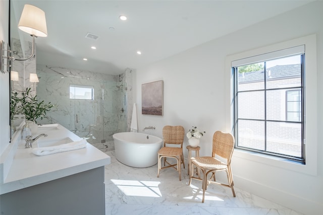 bathroom with vanity and independent shower and bath