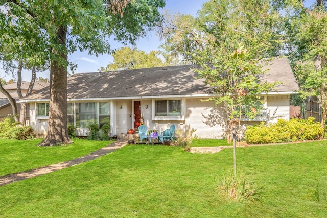 ranch-style home with a front yard