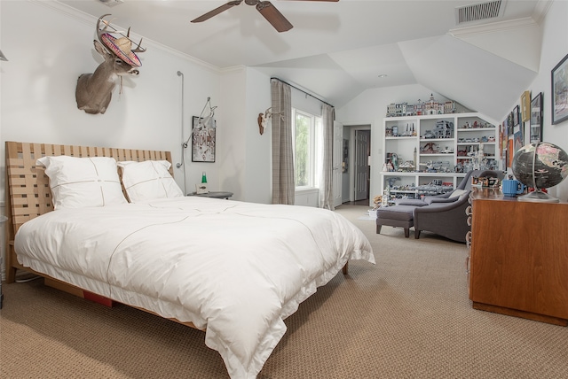 carpeted bedroom with ornamental molding, ceiling fan, and vaulted ceiling