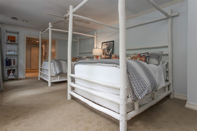 bedroom featuring ceiling fan, crown molding, and light carpet