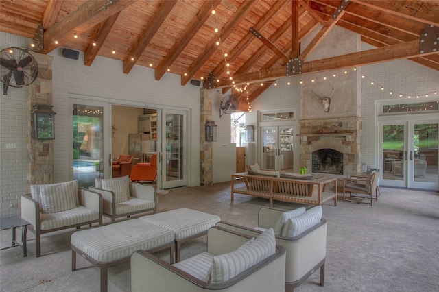 living room featuring brick wall, beamed ceiling, and high vaulted ceiling