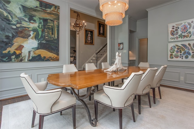 dining room featuring crown molding, a chandelier, and light hardwood / wood-style flooring