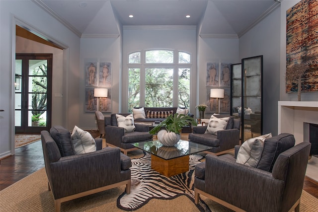 living room with dark hardwood / wood-style floors, ornamental molding, and a wealth of natural light