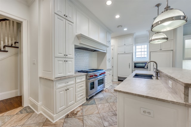 kitchen with pendant lighting, white cabinetry, sink, and stainless steel appliances