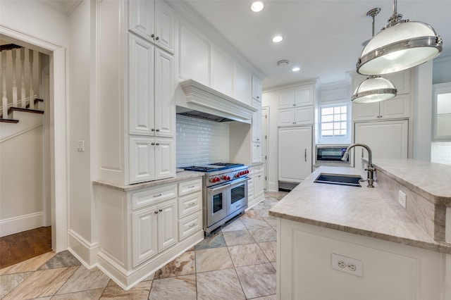 3025 Westminster Ave, University Park, TX 75205 - kitchen featuring recessed lighting, a kitchen island with sink, a sink, premium appliances, and decorative backsplash