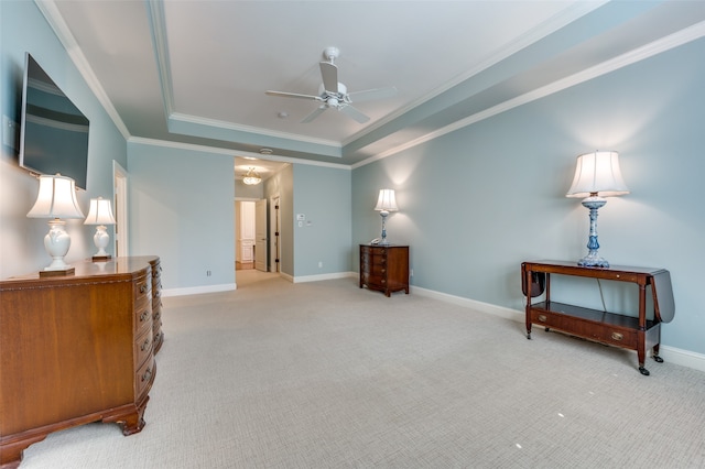 living area with light carpet, a tray ceiling, crown molding, and ceiling fan