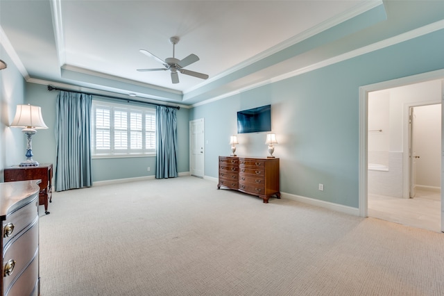 carpeted bedroom featuring ceiling fan, a tray ceiling, connected bathroom, and crown molding