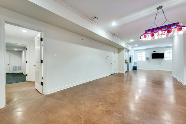 unfurnished living room featuring crown molding and concrete floors