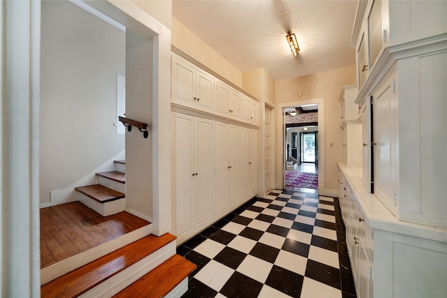 corridor featuring dark floors and stairway