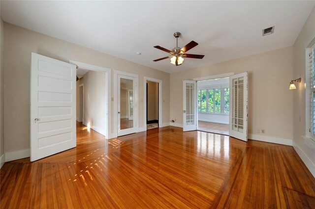 unfurnished sunroom featuring french doors and ceiling fan