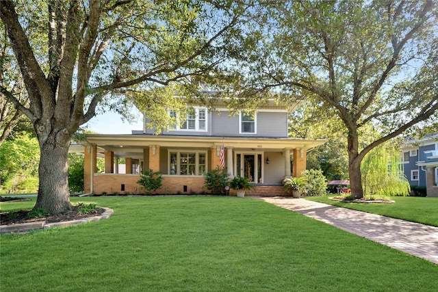 view of front of house with covered porch, brick siding, crawl space, and a front yard