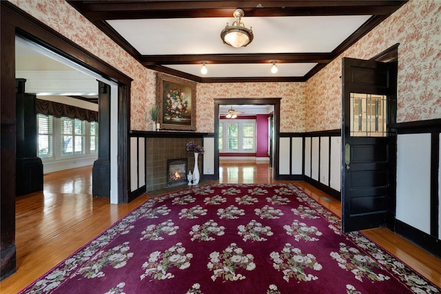 living room featuring a wealth of natural light, a wainscoted wall, and wallpapered walls