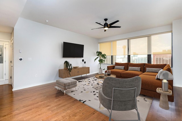 living room featuring ceiling fan and wood-type flooring