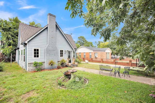 back of house featuring a lawn