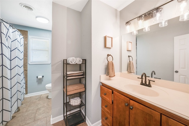 bathroom with tile patterned floors, vanity, and toilet