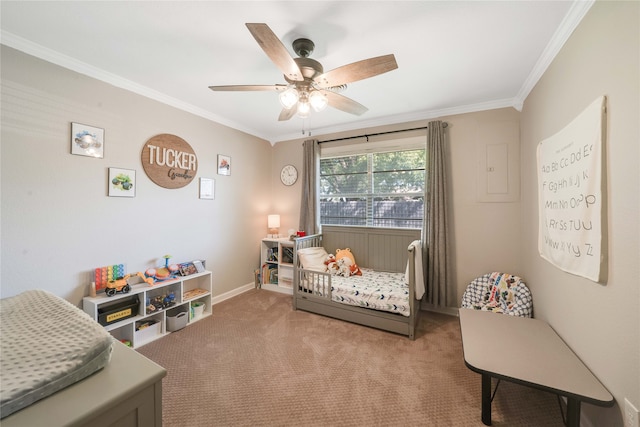 bedroom featuring a nursery area, crown molding, carpet, and ceiling fan