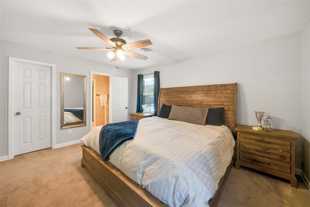 carpeted bedroom with connected bathroom and ceiling fan